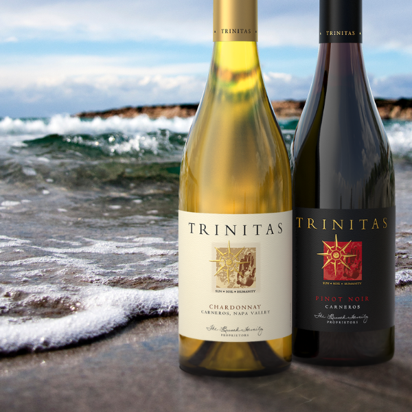 2 Bottles of Trinitas wine on ocean beach
