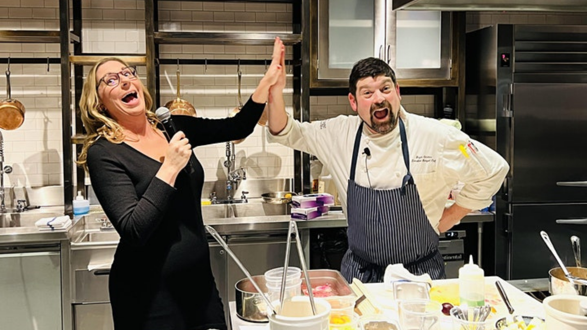 Comedian and chef laughing in the kitchen