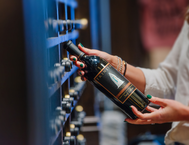 Person selecting bottle of wine