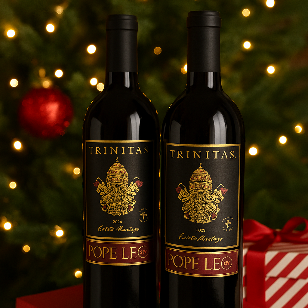Two bottles of Trinitas Pope Leo XIV Estate Meritage with black capsules, elegantly displayed in front of a glowing Christmas tree and festive holiday décor.