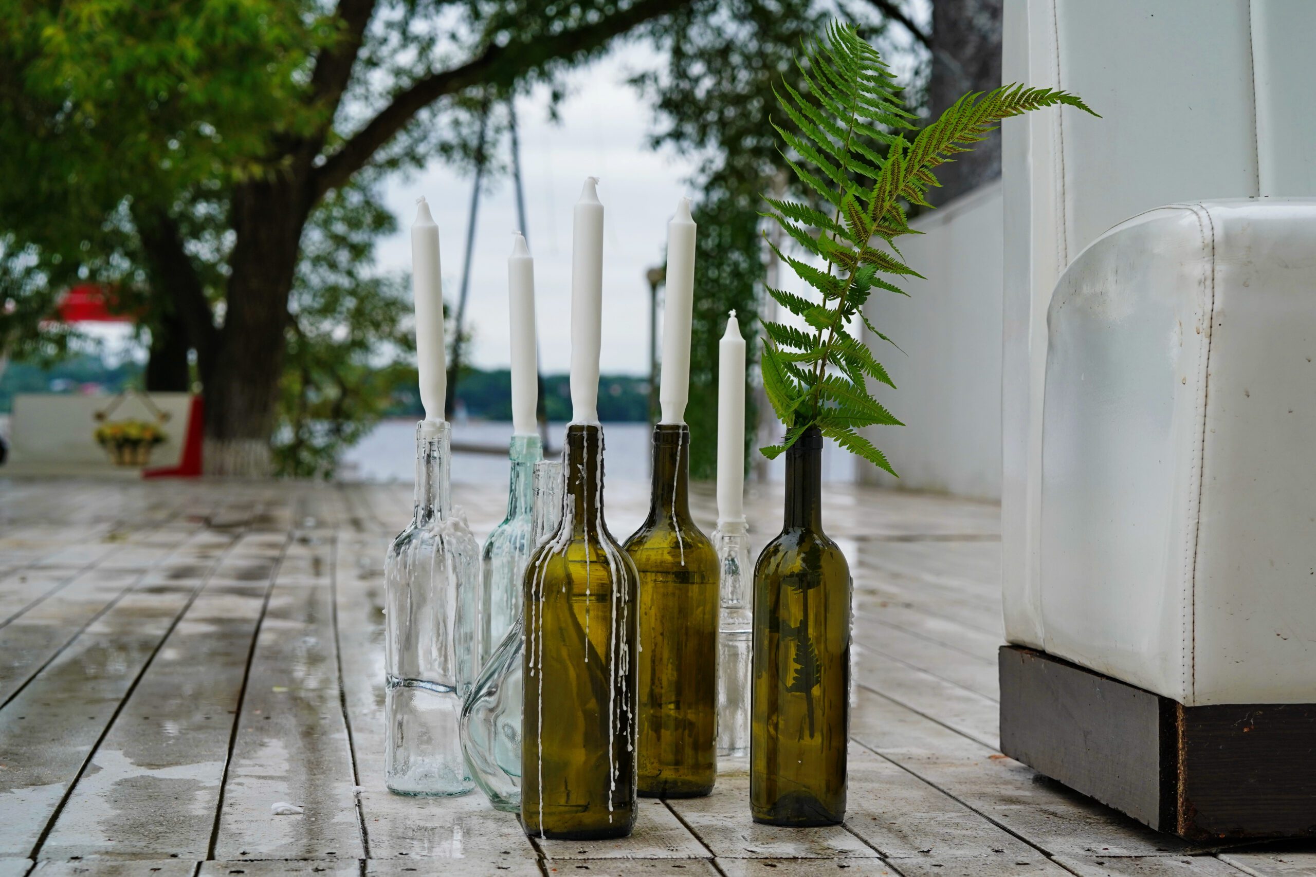 Candles placed in empty wine bottles
