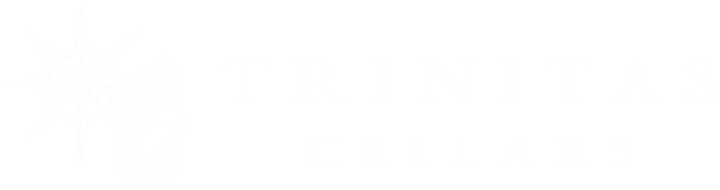 White Trinitas Cellars logo with a sunburst design and a hand next to the text on a light background.