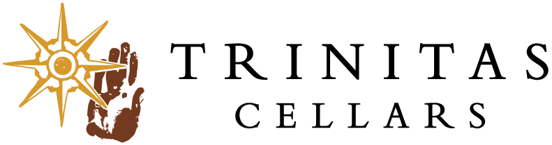 Trinitas Cellars logo with a gold sunburst, a brown handprint, and bold black text.